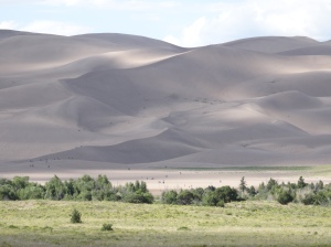 Big sand dunes with teeny-tiny people